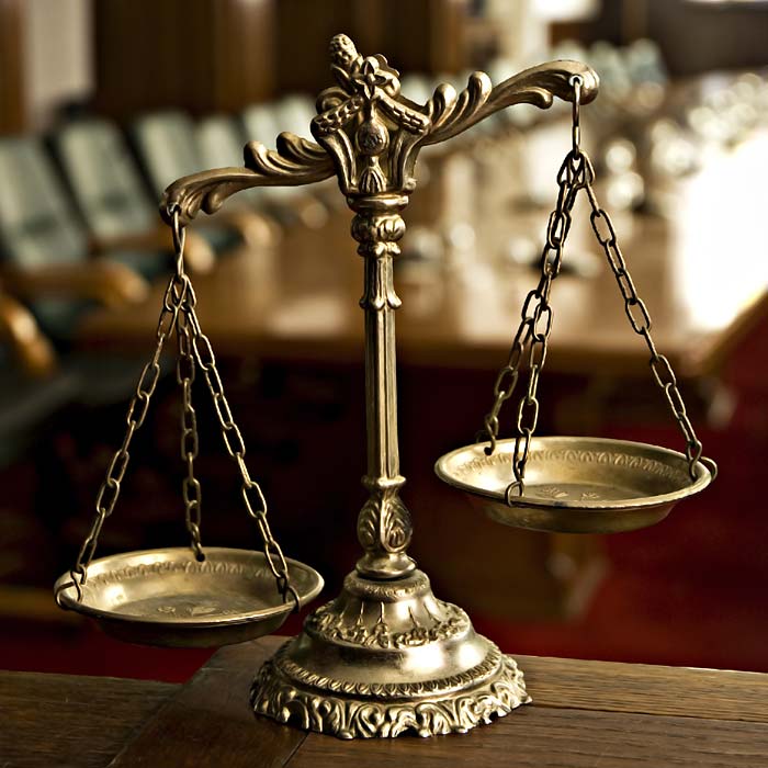 Brass scales of justice in court room