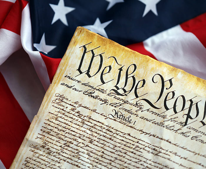 Photo of U.S. Constitution over flag