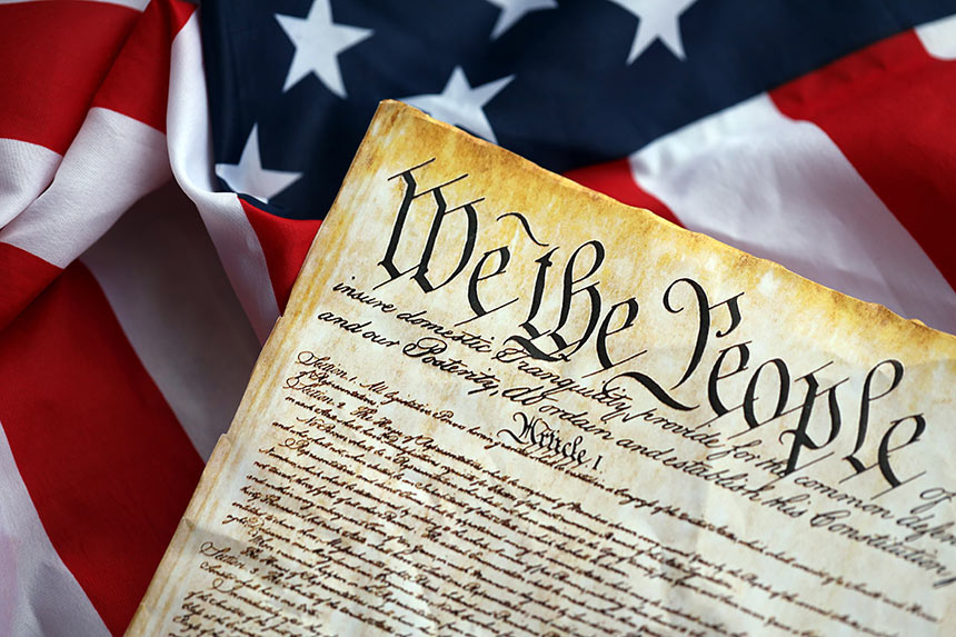 Photo of U.S. Constitution over flag