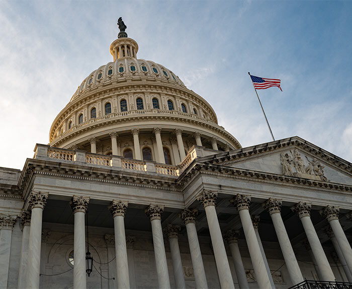 US Capitol Building against blue sky with clouds