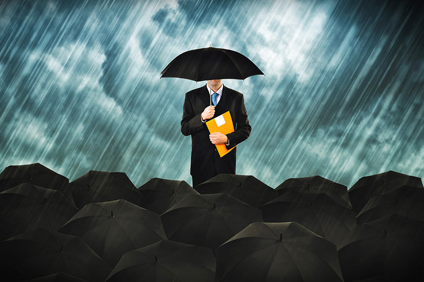 Photo of a man holding an umbrella and a folder in the rain
