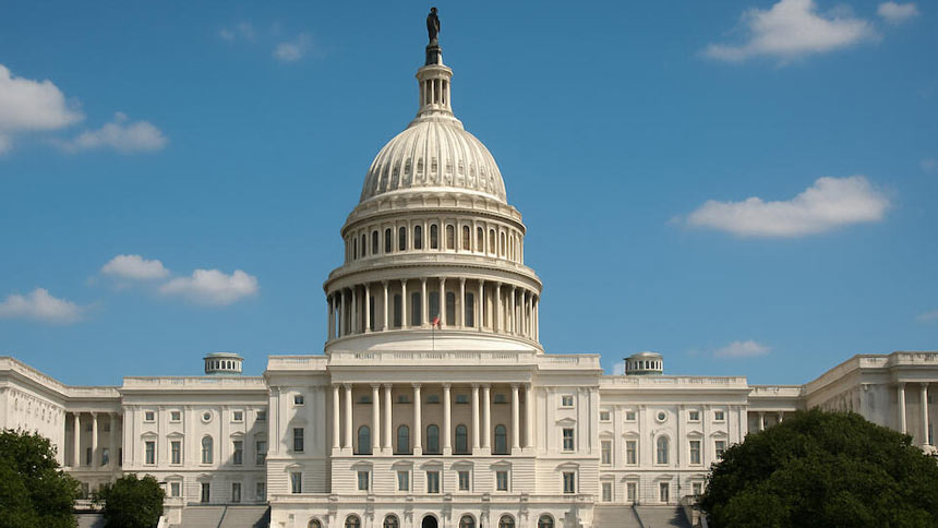 US Capitol Building against blue sky with clouds
