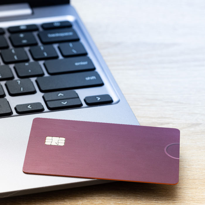Photo of a credit card laying on a laptop