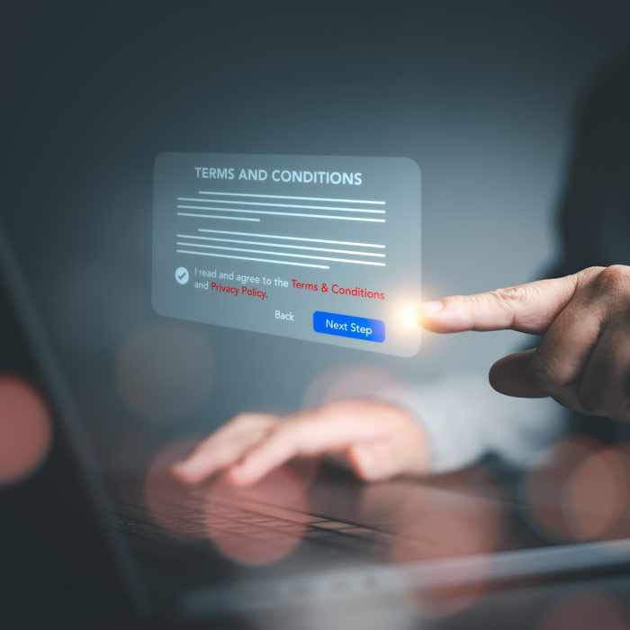 Photo of a person touching digital Terms & Conditions button