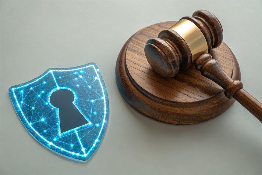 Photo of a gavel and a blue digital shield with a keyhole in center